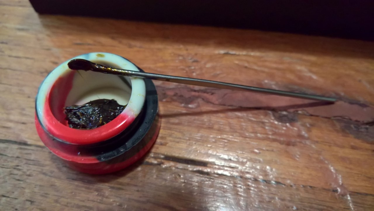 Rosin and tool to scoop into vape coil area.