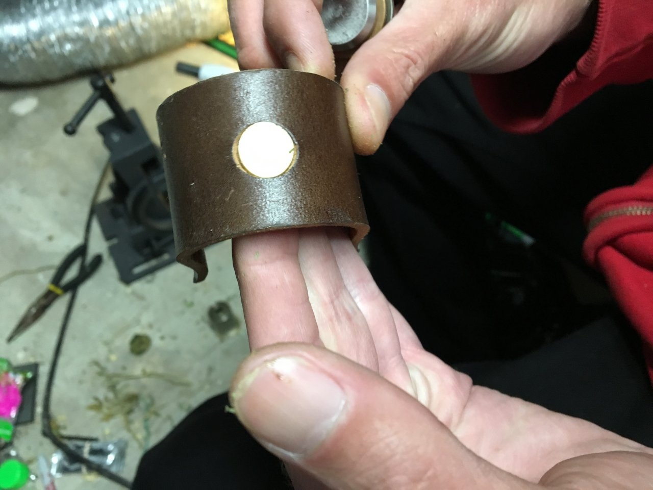 The plug fits into the leather shield for storage.