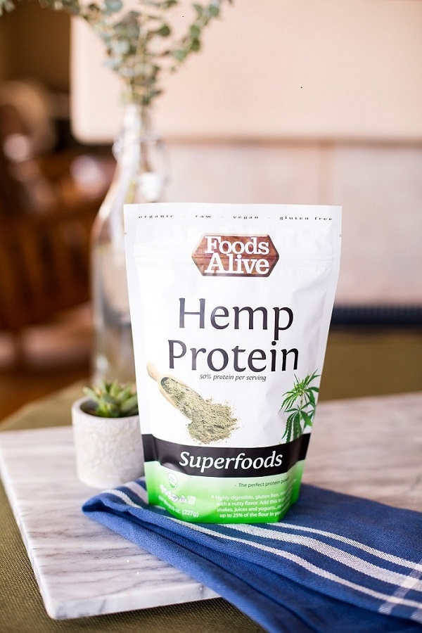 Hemp_Protein_Powder_on_Table_with_Plants_in_Background.jpg