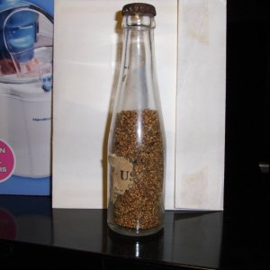Hemp seed in a bottle with partial label.