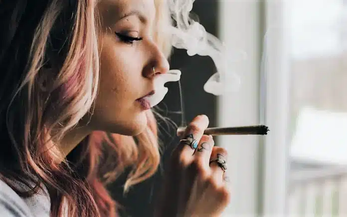 Young woman smoking cannabis Hotels